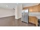 Contemporary kitchen featuring stainless steel appliances and hardwood floors with access to living area at 82 Autumn Day St, Henderson, NV 89012