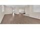 Open-concept living area with wood-look floors and bright neutral paint at 82 Autumn Day St, Henderson, NV 89012