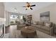 Cozy living area featuring a fireplace, sliding glass doors to the outside, and a ceiling fan at 82 Autumn Day St, Henderson, NV 89012
