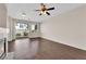 Inviting living area featuring a fireplace, sliding glass doors to the outside, and a ceiling fan at 82 Autumn Day St, Henderson, NV 89012