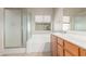 Bright bathroom featuring a bathtub with glass door and a sink at 8266 Lincoln Valley St, Las Vegas, NV 89123