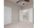 Cozy carpeted bedroom with ceiling fan and large closet doors at 8266 Lincoln Valley St, Las Vegas, NV 89123