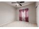 Carpeted bedroom features a ceiling fan and window at 8266 Lincoln Valley St, Las Vegas, NV 89123