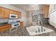 Traditional kitchen with wood cabinets, granite counters, and stainless steel appliances at 8266 Lincoln Valley St, Las Vegas, NV 89123