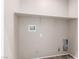 Simple laundry room with shelving and hookups at 8266 Lincoln Valley St, Las Vegas, NV 89123