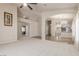 Open-concept living room with plush carpeting, neutral paint, and an archway to the dining area at 8266 Lincoln Valley St, Las Vegas, NV 89123