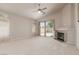 Bright and airy living room with a fireplace, neutral colors, and sliding glass doors that lead to the backyard at 8266 Lincoln Valley St, Las Vegas, NV 89123