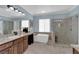 Modern bathroom features a soaking tub, walk-in shower, and dual sink vanity at 8268 Nelson Ridge Ln, Las Vegas, NV 89178