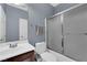 Bathroom featuring a vanity, toilet, and bathtub with sliding glass doors at 8268 Nelson Ridge Ln, Las Vegas, NV 89178