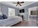 Cozy bedroom with wood floors, large window, and access to the outdoor patio at 8268 Nelson Ridge Ln, Las Vegas, NV 89178