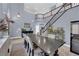 Bright dining room featuring a soaring ceiling, staircase, and large table with seating for six at 8268 Nelson Ridge Ln, Las Vegas, NV 89178