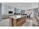 Gourmet kitchen with a large island, stainless steel appliances, and an open layout to the living area at 8268 Nelson Ridge Ln, Las Vegas, NV 89178