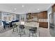 Bright kitchen features a large center island, stainless steel appliances, and adjacent dining area at 8268 Nelson Ridge Ln, Las Vegas, NV 89178