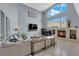 Elegant living room with cozy fireplace, vaulted ceilings, and abundant natural light at 8268 Nelson Ridge Ln, Las Vegas, NV 89178