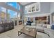 Open-concept living room featuring a fireplace, comfortable seating, and seamless flow to the kitchen and dining areas at 8268 Nelson Ridge Ln, Las Vegas, NV 89178