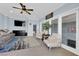Bright living room with sliding glass doors, ceiling fan and comfortable seating at 8268 Nelson Ridge Ln, Las Vegas, NV 89178