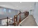 Second story loft with hardwood railing, view to the foyer, and lots of natural light at 8268 Nelson Ridge Ln, Las Vegas, NV 89178