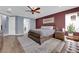 Comfortable main bedroom with a ceiling fan, hardwood floors, and ample natural light at 8268 Nelson Ridge Ln, Las Vegas, NV 89178