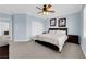 Spacious carpeted main bedroom with a ceiling fan, and large bed with lots of pillows at 8268 Nelson Ridge Ln, Las Vegas, NV 89178