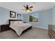 Bright main bedroom with a ceiling fan, lots of pillows and a large window with natural light at 8268 Nelson Ridge Ln, Las Vegas, NV 89178