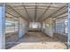 Interior view of covered horse stalls with metal dividers, providing shelter and individual spaces for horses at 8440 La Cienega St, Las Vegas, NV 89123
