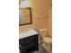 Bathroom featuring single vanity, framed mirror, and a standard toilet at 8455 W Sahara Ave # 213, Las Vegas, NV 89117