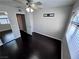 This bedroom has hardwood floors, neutral walls, ceiling fan with light and an open closet at 8455 W Sahara Ave # 213, Las Vegas, NV 89117