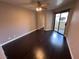 This bedroom features neutral walls, dark wood floors, closet and sliding glass door to balcony at 8455 W Sahara Ave # 213, Las Vegas, NV 89117