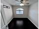 Bright bedroom featuring neutral walls, dark wood floors, a window and ceiling fan with light at 8455 W Sahara Ave # 213, Las Vegas, NV 89117