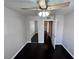 This bedroom features neutral walls, dark wood floors, closet and ceiling fan with light at 8455 W Sahara Ave # 213, Las Vegas, NV 89117