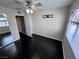 This bedroom has hardwood floors, neutral walls, ceiling fan with light and an open closet at 8455 W Sahara Ave # 213, Las Vegas, NV 89117