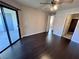 This bedroom features neutral walls, hardwood floors, closet and a sliding glass door to the patio at 8455 W Sahara Ave # 213, Las Vegas, NV 89117
