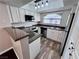Well-lit kitchen with white cabinetry, stainless steel appliances, and granite countertops at 8455 W Sahara Ave # 213, Las Vegas, NV 89117