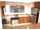 Kitchen with a breakfast bar, tile countertops, and stainless steel appliances at 8455 W Sahara Ave # 213, Las Vegas, NV 89117