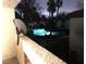 Night view of a well-lit pool area from a balcony at 8455 W Sahara Ave # 213, Las Vegas, NV 89117