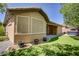 Spacious backyard featuring artificial turf, mature trees, a patio area, and a hot tub, great for outdoor activities at 8544 Garden Valley Ct, Las Vegas, NV 89178