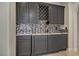 Stylish bar area with dark cabinets, mosaic backsplash, and a countertop for serving beverages at 8544 Garden Valley Ct, Las Vegas, NV 89178