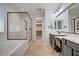 Bright bathroom features a soaking tub, glass shower, double vanity, and walk-in closet access at 8544 Garden Valley Ct, Las Vegas, NV 89178
