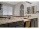 Bathroom featuring a large mirror above the granite countertop vanity with dual sinks at 8544 Garden Valley Ct, Las Vegas, NV 89178