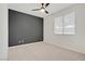 Bedroom with neutral carpet and dark gray accent wall at 8544 Garden Valley Ct, Las Vegas, NV 89178