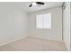 Bedroom features neutral carpet, a ceiling fan, and a window for natural light at 8544 Garden Valley Ct, Las Vegas, NV 89178