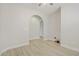 Bonus room featuring arched doorways and light colored wood-look flooring at 8544 Garden Valley Ct, Las Vegas, NV 89178