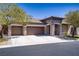 Charming single-story home with a stone facade, three-car garage, and a well-manicured front yard at 8544 Garden Valley Ct, Las Vegas, NV 89178