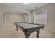 Game room with a classic billiards table, neutral tones, and large windows for natural light at 8544 Garden Valley Ct, Las Vegas, NV 89178