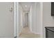 Hallway with multiple arches, white walls, and light colored wood-look flooring at 8544 Garden Valley Ct, Las Vegas, NV 89178