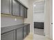 Laundry room with dark gray cabinets and granite counters, connecting to an interior walk-in closet at 8544 Garden Valley Ct, Las Vegas, NV 89178