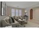 Bright living room with neutral tones, large windows, and stylish furniture, creating a welcoming atmosphere at 8544 Garden Valley Ct, Las Vegas, NV 89178