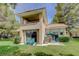 Spacious backyard featuring patio seating, grill, grass, and a lush landscaping at 8591 Heather Downs Dr, Las Vegas, NV 89113