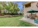 Inviting backyard patio with grill, outdoor seating, and a view of the well-maintained lawn at 8591 Heather Downs Dr, Las Vegas, NV 89113