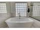 Elegant bathroom with large soaking tub and beautiful tiled window at 8591 Heather Downs Dr, Las Vegas, NV 89113